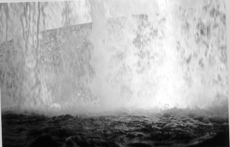 The view looking out from behind the falls